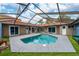 Enclosed screened in pool surrounded by a red tiled roof, with patio access to the home at 5015 Nassau Cir # 4, Orlando, FL 32808
