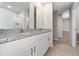 Bathroom featuring double vanity with granite countertop, tile flooring, and white cabinets at 5288 Stephs Field St, St Cloud, FL 34771