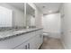 Bright bathroom with granite countertop, white cabinets, and combined shower and tub at 5288 Stephs Field St, St Cloud, FL 34771