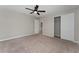 Bedroom with an ensuite bathroom, neutral walls, closet, and carpet at 5288 Stephs Field St, St Cloud, FL 34771