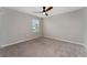 Bedroom with neutral walls, plush carpeting, ceiling fan, and a window providing natural light at 5288 Stephs Field St, St Cloud, FL 34771