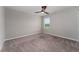 Bright bedroom with neutral walls, plush carpeting, and a window providing natural light at 5288 Stephs Field St, St Cloud, FL 34771