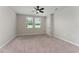 Large, neutral bedroom features two windows, ceiling fan and plush carpet at 5288 Stephs Field St, St Cloud, FL 34771