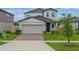 Charming two-story home with a brick driveway, attached two car garage, and well-manicured lawn at 5288 Stephs Field St, St Cloud, FL 34771