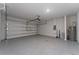 Spacious two car garage with epoxy flooring, storage shelving and lighting at 5288 Stephs Field St, St Cloud, FL 34771