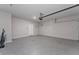 Spacious two car garage with epoxy flooring, storage shelving and lighting at 5288 Stephs Field St, St Cloud, FL 34771