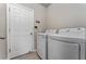 Bright laundry room with modern washer and dryer appliances at 5288 Stephs Field St, St Cloud, FL 34771