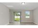 Bright living room features tile floors, large windows, sliding glass door to backyard, and neutral paint at 5288 Stephs Field St, St Cloud, FL 34771