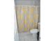 Bathroom featuring a tiled shower with a decorative curtain at 5810 Paradise Ln, Orlando, FL 32808