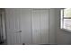 This bedroom features a closet with folding doors and a window at 5810 Paradise Ln, Orlando, FL 32808