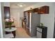Well-lit kitchen featuring stainless steel appliances, dark wood cabinetry, and tiled floors at 5810 Paradise Ln, Orlando, FL 32808