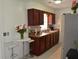 The kitchen has dark wood cabinets, backsplash, and stainless steel appliances at 5810 Paradise Ln, Orlando, FL 32808