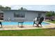 Backyard pool with patio space offers a great space for relaxing and entertaining outdoors at 5810 Paradise Ln, Orlando, FL 32808