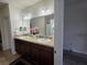 Bathroom featuring double sinks with modern fixtures, vanity lighting, and a large mirror at 585 Lucerne Blvd, Winter Haven, FL 33881