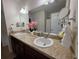 Bathroom featuring double sinks with modern fixtures, vanity lighting, and a large mirror at 585 Lucerne Blvd, Winter Haven, FL 33881