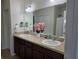 Bathroom featuring double sinks with modern fixtures, vanity lighting, and a large mirror at 585 Lucerne Blvd, Winter Haven, FL 33881