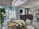 Dining area with marble table, chairs, and view of the modern living room and outdoor patio at 585 Lucerne Blvd, Winter Haven, FL 33881