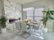 Elegant dining room featuring a marble fireplace, modern chandelier, and stylish chairs at 585 Lucerne Blvd, Winter Haven, FL 33881