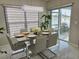 Elegant dining room features a modern table, stylish chairs, and seamless access to the outdoor deck at 585 Lucerne Blvd, Winter Haven, FL 33881