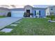 Charming single-story home with well-manicured lawn and stone accents at 585 Lucerne Blvd, Winter Haven, FL 33881