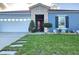 Delightful single-story home with walkway, two-car garage, and manicured front lawn at 585 Lucerne Blvd, Winter Haven, FL 33881