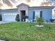 Attractive single-story home with a well-kept lawn, landscape lighting, and stone accents at 585 Lucerne Blvd, Winter Haven, FL 33881