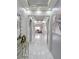 Hallway with marble floors, recessed lighting, and view to living room at 585 Lucerne Blvd, Winter Haven, FL 33881