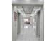 Hallway with marble floors, recessed lighting, and view to living room at 585 Lucerne Blvd, Winter Haven, FL 33881