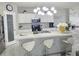 Well-lit kitchen with white cabinetry, pantry door, stainless steel appliances, and modern finishes at 585 Lucerne Blvd, Winter Haven, FL 33881