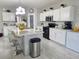 Modern kitchen featuring white cabinetry, stainless steel appliances, and a functional center island at 585 Lucerne Blvd, Winter Haven, FL 33881