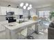 Open-concept kitchen featuring a large island, stainless appliances, and adjacent dining area at 585 Lucerne Blvd, Winter Haven, FL 33881