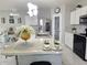 Bright kitchen with quartz countertops, stainless steel appliances, and a spacious center island at 585 Lucerne Blvd, Winter Haven, FL 33881