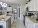 Modern kitchen featuring white cabinets, stainless steel appliances, and a center island with a sink at 585 Lucerne Blvd, Winter Haven, FL 33881