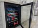 Beverage refrigerator in kitchen island with open door to show contents at 585 Lucerne Blvd, Winter Haven, FL 33881