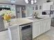 Kitchen island includes beverage fridge and large sink, opening to the living room at 585 Lucerne Blvd, Winter Haven, FL 33881