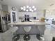 Open kitchen with white cabinets, an island, and stainless steel appliances with bar stool seating at 585 Lucerne Blvd, Winter Haven, FL 33881