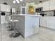 Bright kitchen featuring white cabinets, an island with seating, and stainless steel appliances at 585 Lucerne Blvd, Winter Haven, FL 33881