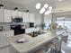 Open concept kitchen with island seating, white cabinetry, and modern appliances at 585 Lucerne Blvd, Winter Haven, FL 33881