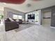 Contemporary living room featuring a gray sectional sofa, a glass coffee table, and a sleek entertainment center at 585 Lucerne Blvd, Winter Haven, FL 33881