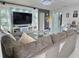 Open-concept living room with a large gray sectional, media center, and stylish decor at 585 Lucerne Blvd, Winter Haven, FL 33881