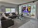 Comfortable living room features a large sectional sofa, stylish decorations and a decorative tv wall unit at 585 Lucerne Blvd, Winter Haven, FL 33881