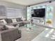 Stylish living room with custom entertainment center, large sectional couch, and lots of bright light at 585 Lucerne Blvd, Winter Haven, FL 33881