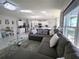 Spacious living room with a comfortable sectional sofa, a glass coffee table, and a view of the kitchen at 585 Lucerne Blvd, Winter Haven, FL 33881