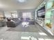 Open-concept living room showcases a custom entertainment center, providing ample space for relaxation at 585 Lucerne Blvd, Winter Haven, FL 33881