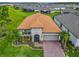 Aerial view of home showing meticulous landscaping, paved driveway, and tile roof at 605 San Augusto Dr, Kissimmee, FL 34759