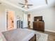 This bedroom features an en-suite bathroom and views of the living room and entry hallway at 605 San Augusto Dr, Kissimmee, FL 34759