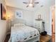Comfortable bedroom with wood-look floors, ceiling fan, and a double bed with charming quilt at 605 San Augusto Dr, Kissimmee, FL 34759