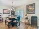 Cozy dining area featuring a modern chandelier, unique decor, and ample natural light at 605 San Augusto Dr, Kissimmee, FL 34759