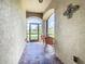 Screened-in entryway with tiled floor and arched windows providing lots of light at 605 San Augusto Dr, Kissimmee, FL 34759