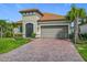 Charming home featuring tile roof, paver driveway, and well-maintained landscaping at 605 San Augusto Dr, Kissimmee, FL 34759